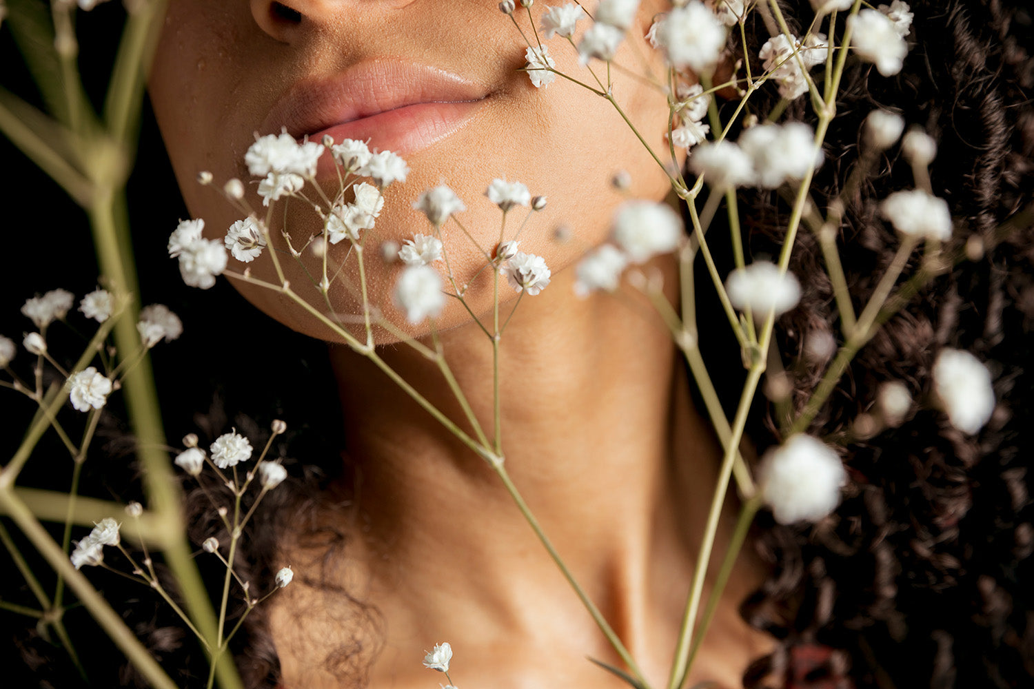 woman holding white flowers